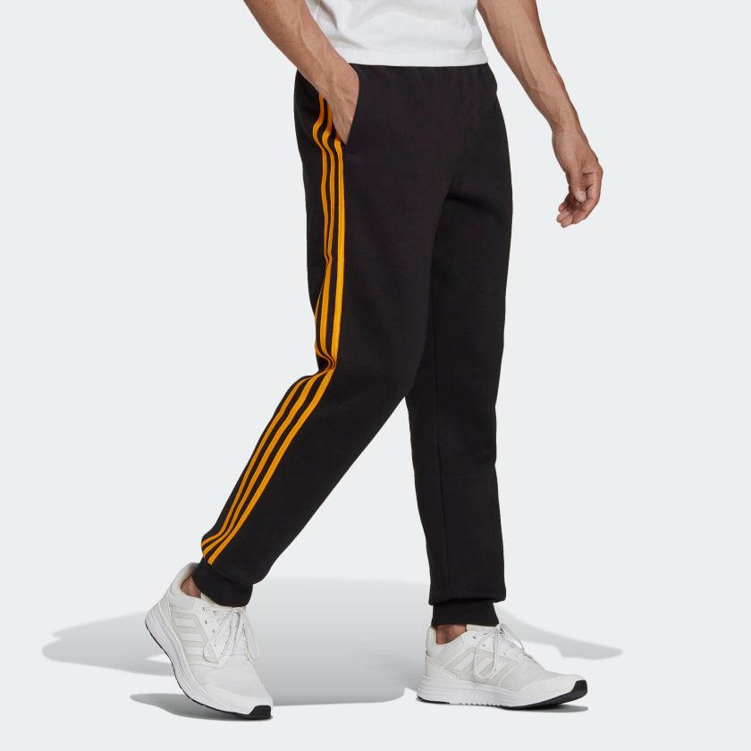PANTALONI ESSENTIALS FRENCH TERRY CON POLSINI AFFUSOLATI E 3 STRISCE - Azzollino